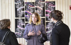 An artist discusses her work with art professors. 